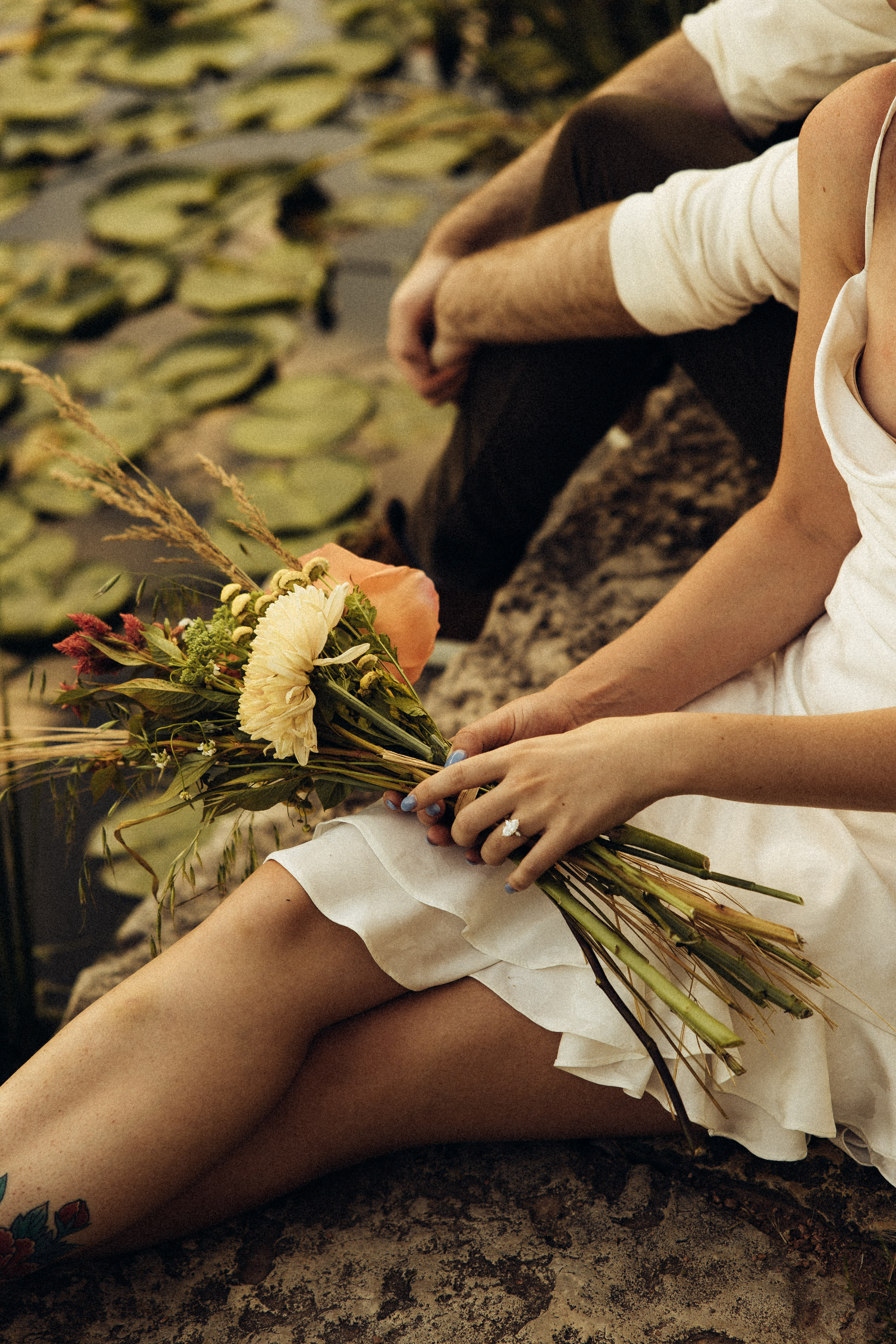 3 flowers placed in a vintage glass jar with a soft green background.